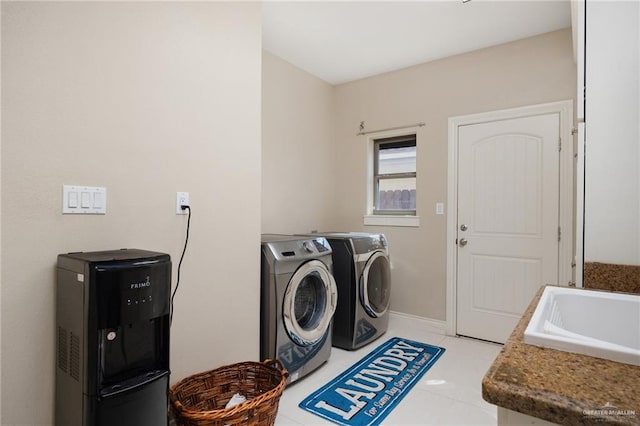 laundry room with washing machine and dryer, sink, and light tile patterned floors