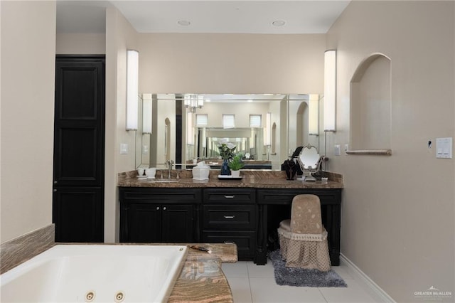 bathroom with tile patterned flooring, vanity, and a tub