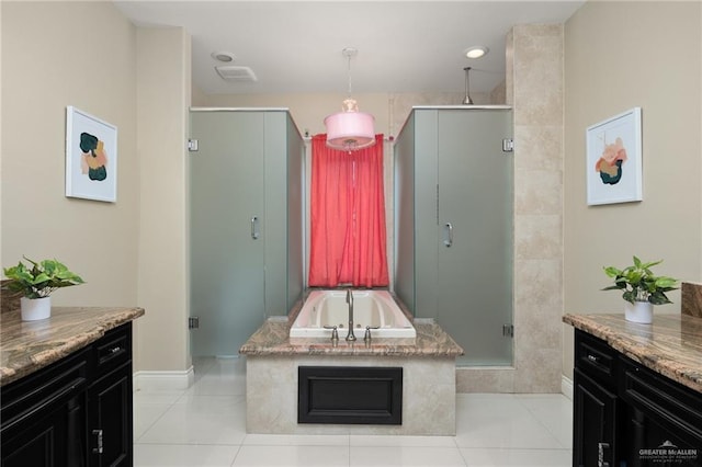 bathroom with tile patterned floors, vanity, and shower with separate bathtub