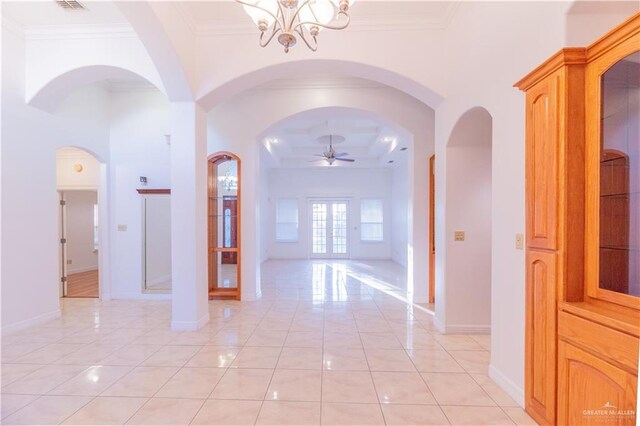 hallway with light tile patterned floors, a chandelier, baseboards, and ornamental molding