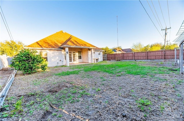 rear view of property with french doors and a fenced backyard