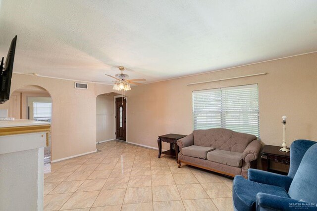 1106 17th St, Mcallen, TX 78501 - living room featuring arched walkways, ceiling fan, and light tile patterned floors