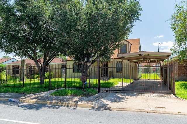 1106 17th St, Mcallen, TX 78501 - view of property hidden behind natural elements featuring a fenced front yard, a gate, a carport, and concrete driveway