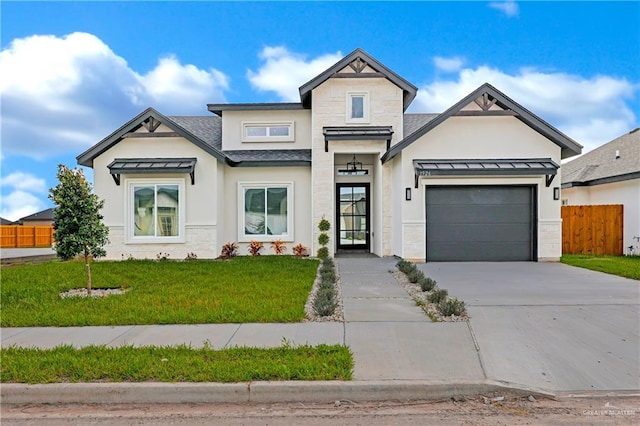 view of front of property with a garage and a front yard