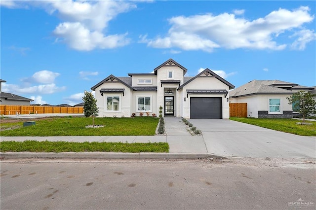 view of front of property featuring a garage and a front yard