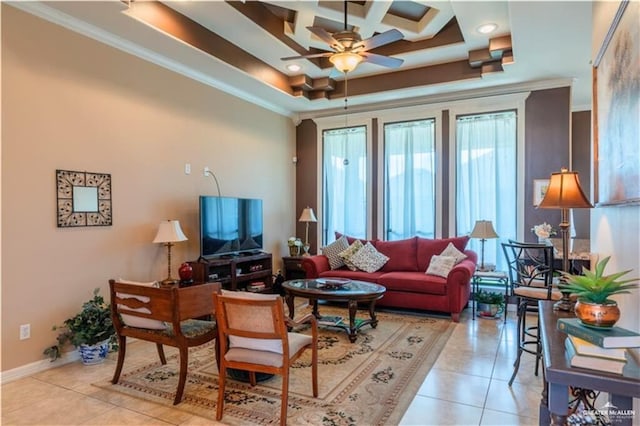 living room with ceiling fan, light tile patterned floors, a tray ceiling, and ornamental molding