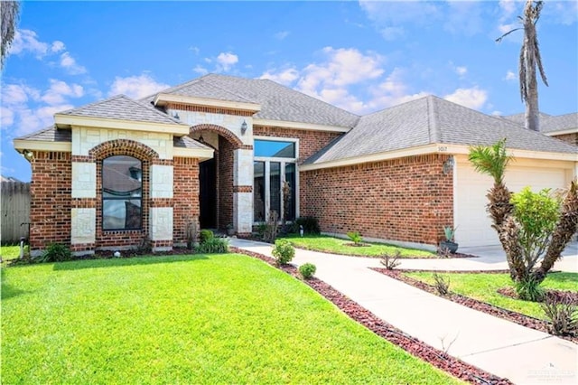 view of front of house with a garage and a front yard