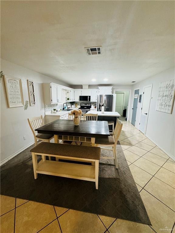 tiled dining room with sink