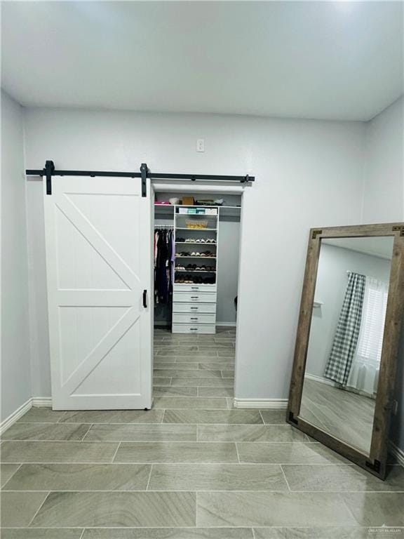 spacious closet featuring a barn door