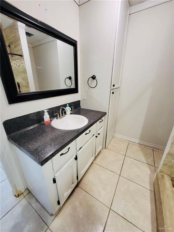 bathroom with tile patterned floors and vanity