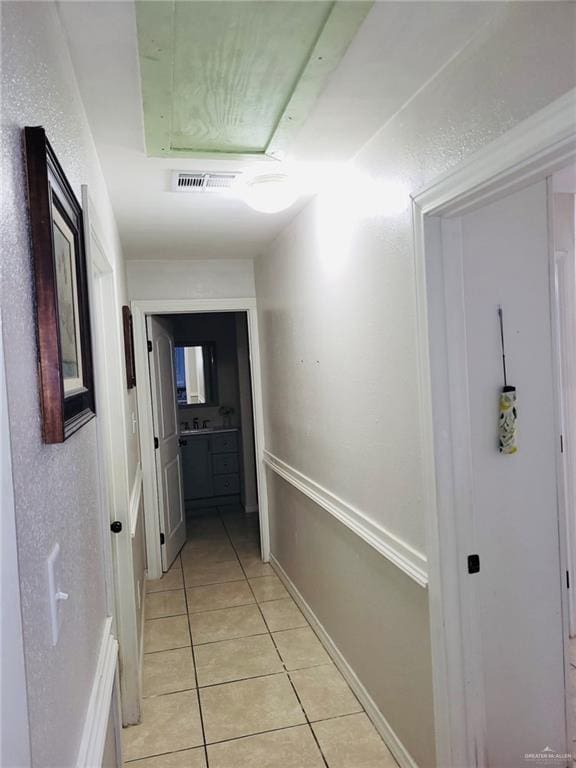 corridor featuring light tile patterned floors