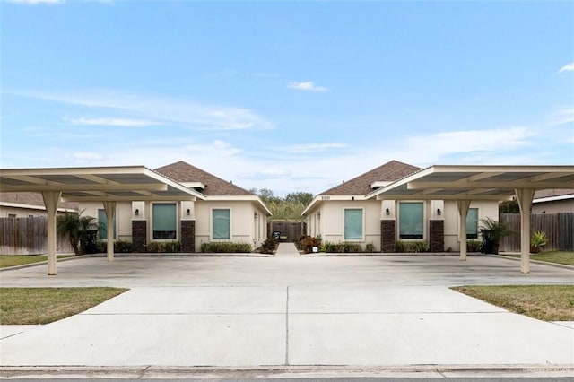 1909 Taft St, Weslaco, TX 78596 - view of front of home featuring fence, stucco siding, and stone siding