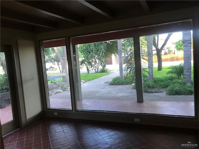 1316 W Maple Ave, Mcallen, TX 78501 - doorway with dark tile patterned flooring, beam ceiling, and healthy amount of natural light