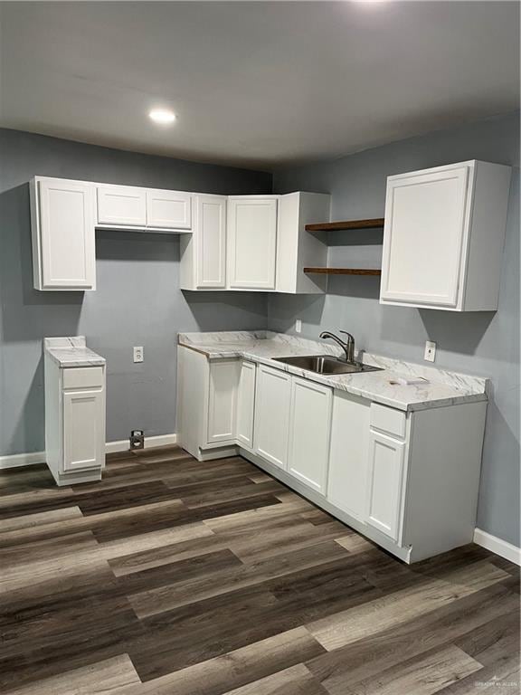 306 W 3rd St, San Juan, TX 78589 - kitchen with white cabinets, open shelves, a sink, baseboards, and dark wood-type flooring