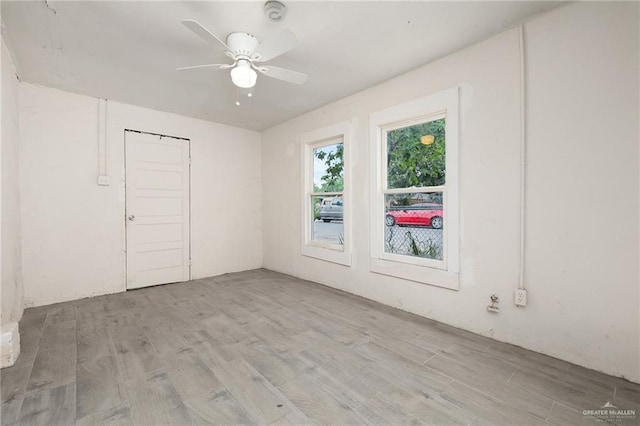 empty room with light wood-type flooring and ceiling fan