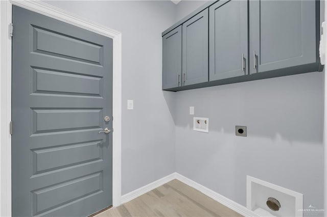 laundry room featuring cabinets, hookup for a washing machine, light wood-type flooring, and electric dryer hookup