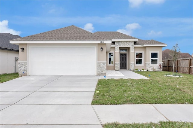 prairie-style home featuring a garage and a front lawn