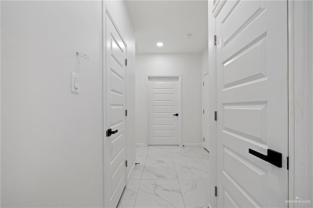 hallway featuring recessed lighting, marble finish floor, and baseboards