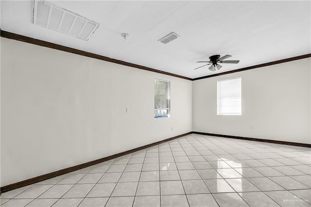 empty room with ceiling fan, light tile patterned flooring, and crown molding