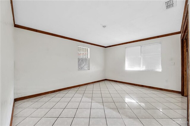 tiled spare room with crown molding