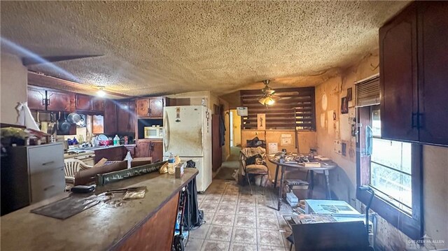 816 N Carlson St, Elsa, TX 78543 - kitchen featuring white appliances, ceiling fan, a textured ceiling, light flooring, and dark countertops