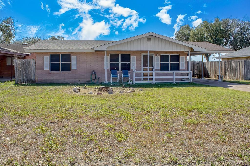 rear view of property featuring a yard