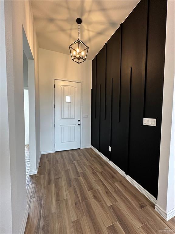 foyer with hardwood / wood-style floors and an inviting chandelier