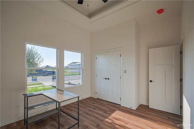 unfurnished office with ceiling fan and hardwood / wood-style flooring