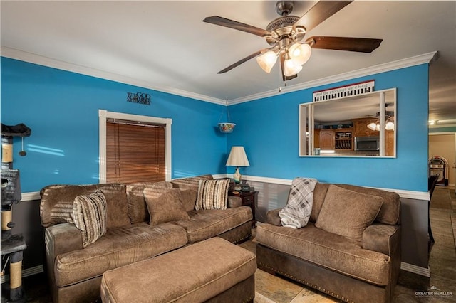 living area featuring ceiling fan, ornamental molding, and baseboards