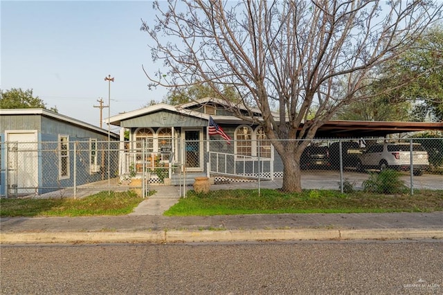 view of front of house featuring a fenced front yard and an attached carport