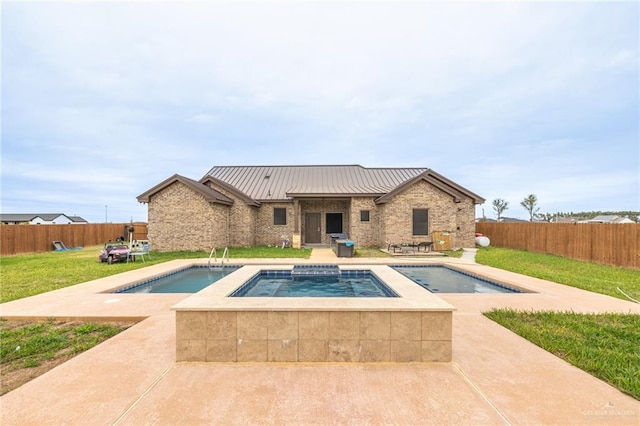 view of pool with a fenced backyard, a fenced in pool, and an in ground hot tub