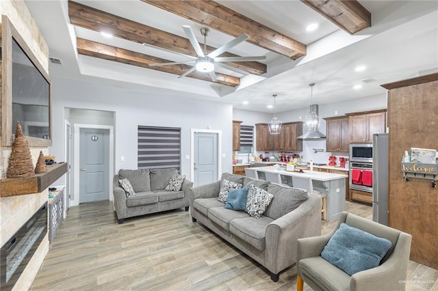 living room featuring a ceiling fan, light wood-type flooring, beam ceiling, and recessed lighting