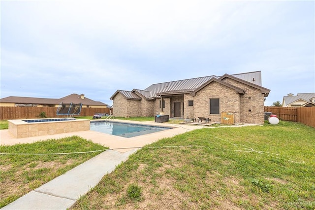 view of pool with a fenced in pool, a fenced backyard, a yard, and an in ground hot tub