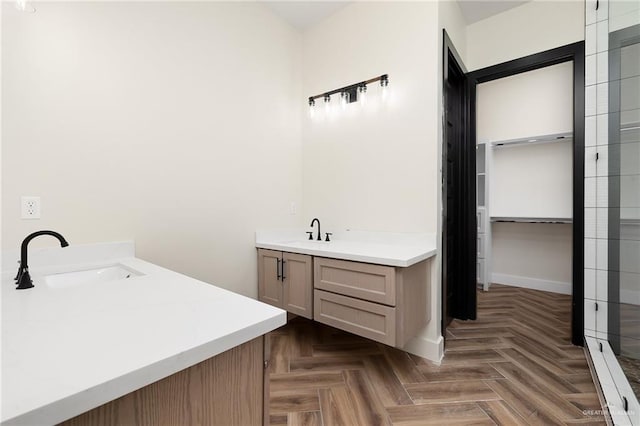 bathroom with vanity and parquet floors