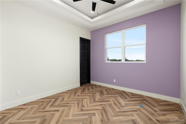 spare room with ceiling fan and light parquet floors