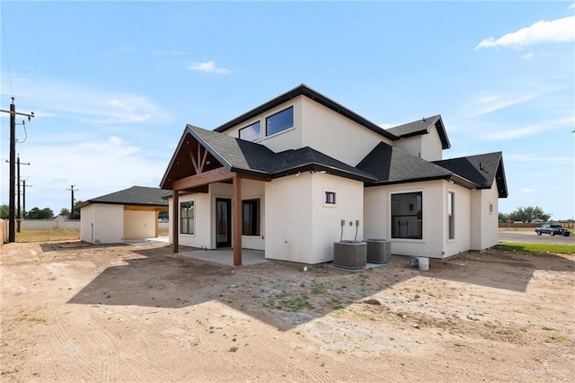 rear view of property featuring central AC and a patio