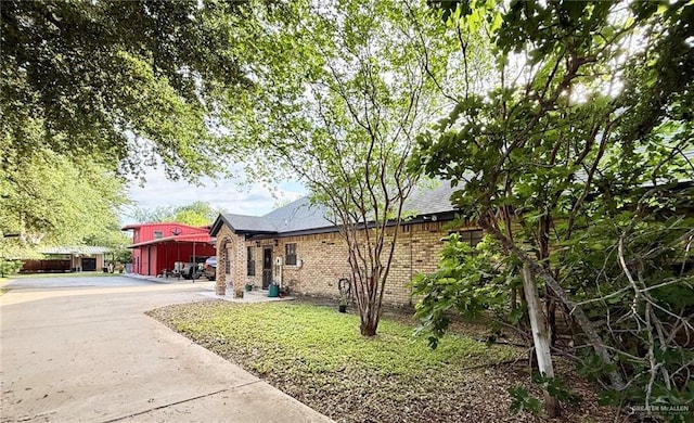 6101 Mile 7 Rd, Mission, TX 78573 - view of home's exterior featuring brick siding and roof with shingles