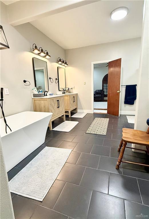 6101 Mile 7 Rd, Mission, TX 78573 - full bath with a freestanding tub, double vanity, tile patterned flooring, and baseboards