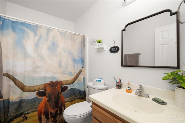 bathroom featuring vanity and toilet