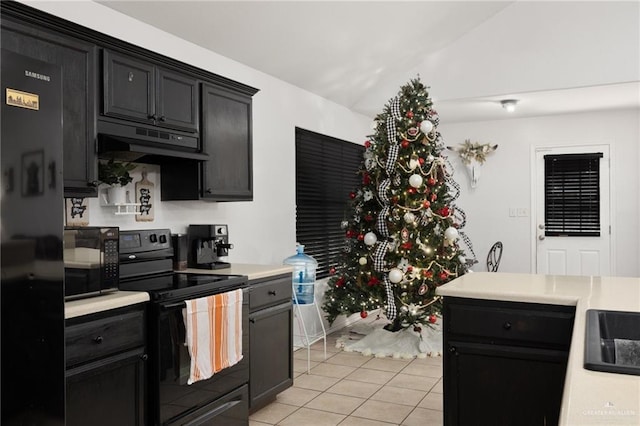 kitchen with light tile patterned floors, black appliances, and lofted ceiling