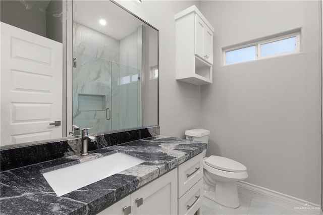 528 Candela St, Edinburg, TX 78542 - full bathroom featuring toilet, a marble finish shower, baseboards, and vanity