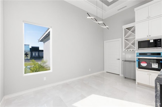 528 Candela St, Edinburg, TX 78542 - kitchen featuring white cabinets, a wealth of natural light, stainless steel oven, and built in microwave