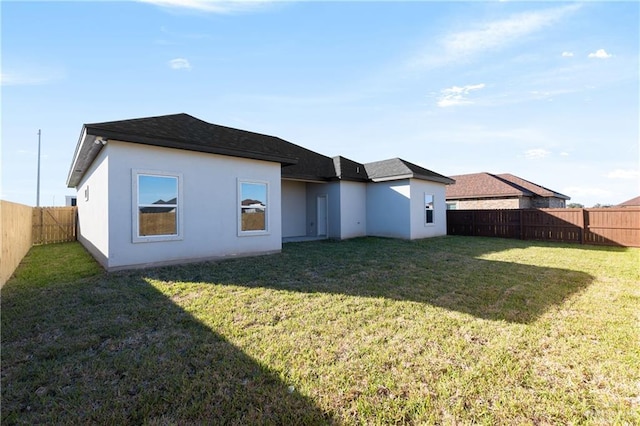 528 Candela St, Edinburg, TX 78542 - back of house featuring a lawn, a fenced backyard, and stucco siding