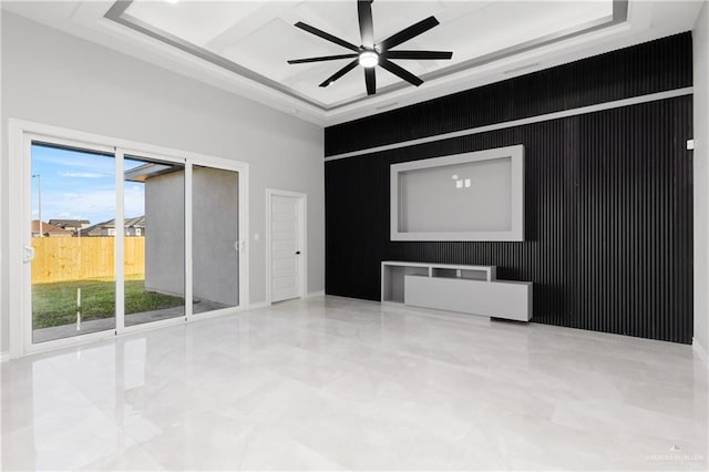 interior space featuring a tray ceiling, ceiling fan, and a towering ceiling