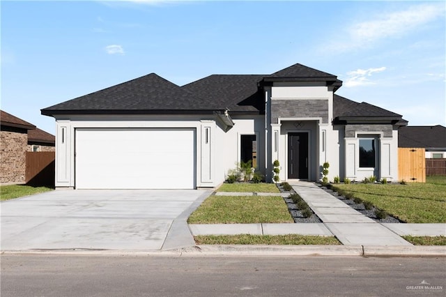 view of front of home featuring an attached garage, driveway, fence, and a shingled roof