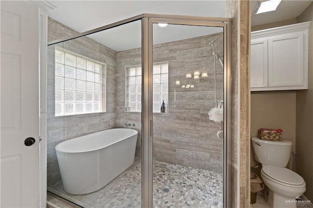 1602 Meadow Ln, Harlingen, TX 78550 - full bathroom featuring a freestanding tub, a stall shower, and toilet