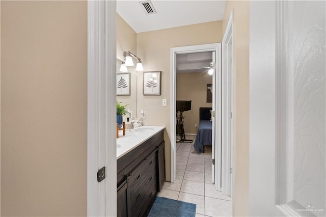 1602 Meadow Ln, Harlingen, TX 78550 - ensuite bathroom featuring double vanity, tile patterned flooring, and a ceiling fan