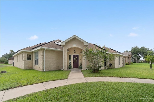 1602 Meadow Ln, Harlingen, TX 78550 - ranch-style home with solar panels and a front yard