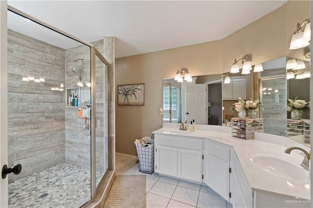 1602 Meadow Ln, Harlingen, TX 78550 - full bathroom featuring tile patterned floors, a shower stall, double vanity, and baseboards