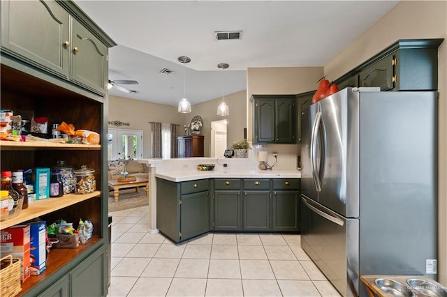 1602 Meadow Ln, Harlingen, TX 78550 - kitchen featuring freestanding refrigerator, a peninsula, green cabinets, and light tile patterned floors